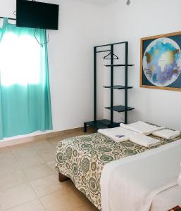 a bedroom with a bed and a window at Apart Hotel Bell in San Fernando del Valle de Catamarca +23 photos