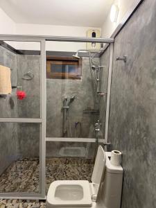 a bathroom with a shower and a toilet at Taco Super Place in Unawatuna