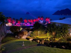 a view of a resort at night with red lights at KAY TI'TINY T2 NEUF de STANDING MER & PISCINE in Le Diamant
