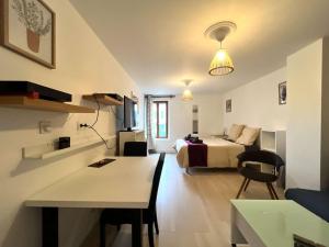 a hotel room with a bed and a desk and a room at City Center - Duplex Studio - Close to RER in Saint-Germain-en-Laye
