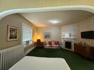 a hotel room with a bed and a fireplace at Windsor Inn Hotel in Washington, D.C.