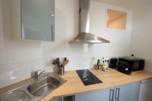 a kitchen counter with a sink and a microwave at Studio number 10 in Pantin +45 photos