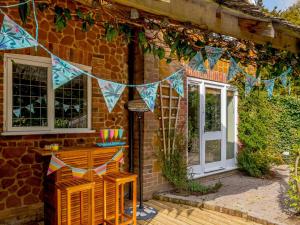 a house with a string of flags on the side of it at The Old Gatehouse in Heacham