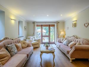 a large living room with couches and a table at The Old Gatehouse in Heacham