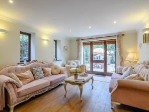 a living room with two couches and a table at The Old Gatehouse in Heacham