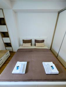 a bed in a room with two towels on it at Lihnidos Home, Central Stay, Wi-Fi, near Lake, AC in Ohrid