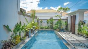 a swimming pool in the backyard of a house at Villa Griya Anyar Ubud in Ubud