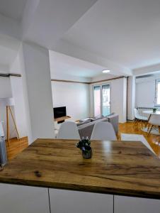 a living room with a wooden table and chairs at Lihnidos Home, Central Stay, Wi-Fi, near Lake, AC in Ohrid