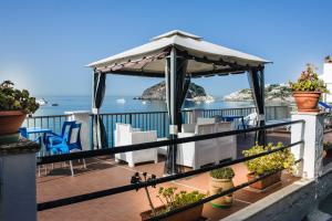 a patio area with chairs and umbrellas at Hotel Regina del Mare in Ischia