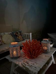 three vases sitting on a table in a room at Villa Bellavista Chia in Chia