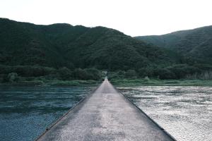 a bridge over a river with mountains in the background at Shimanto Suite By Hideaway  +28 photos