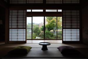a room with a window and a table and pillows at Shimanto Suite by Hideaway in Shimanto