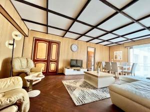 a living room with a couch and a table at 2 Bedroom 120 m2 with Terrace & Parking near La Défense & Champs Elysees in Neuilly-sur-Seine