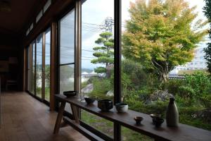 a room with a table and a large window at Shimanto Suite By Hideaway 