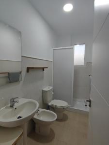 a white bathroom with a sink and a toilet at La Casa del Valle in Blanca +30 photos