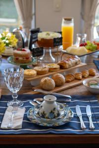 a table topped with pastries and other pastries on a table at L.A.H. Hostellerie in Campos do Jordão