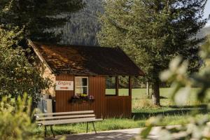a small building with a bench in front of it at Landhaus im Feld in Sankt Michael im Lungau +10 photos