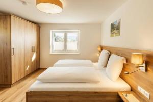 a bedroom with two beds and a window at Landhaus im Feld in Sankt Michael im Lungau