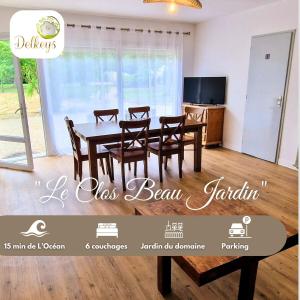 a dining room with a table and chairs and a tv at Le Clos Beau Jardin in Gaillan-en-Médoc
