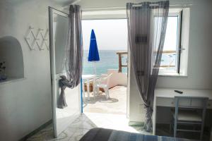 a door to a room with a view of the ocean at Hotel Regina del Mare in Ischia
