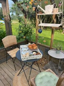 a table with a tray of food on a patio at Songe de Clarté in Plouigneau