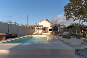 a swimming pool in the backyard of a house at Petrochori Beach House in Voidokilia
