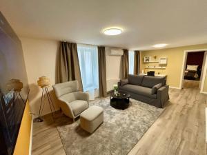 a living room with a couch and two chairs at Golden Tulip Kassel Hotel Reiss in Kassel