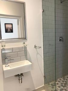 a bathroom with a sink and a shower at Modern Apartment - Home away from home in Summerstrand