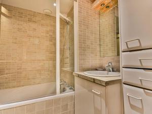 a bathroom with a tub and a sink and a shower at Spacieux T4 proche des pistes avec terrasse et parking - 6-8 pers. - FR-1-685-22 in Les Gets +5 photos