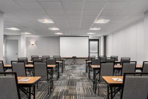 an empty classroom with tables and chairs and a whiteboard at Homewood Suites by Hilton Newtown - Langhorne, PA in Newtown +37 photos