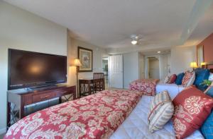 a hotel room with two beds and a flat screen tv at Barefoot Yacht Club Villas - 1-805 in Myrtle Beach +33 photos