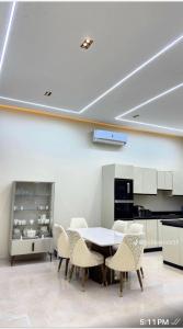 a dining room with a table and chairs at Reef Golden Resort شاليه الريف الذهبي in Qaryat ash Shamālī