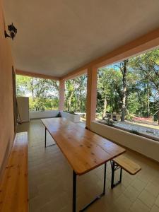 a large room with a wooden table and large windows at Villa with Garden near Rome for Groups & Families in Orte