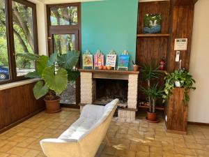 a living room with two chairs and a fireplace at Villa with Garden near Rome for Groups & Families in Orte