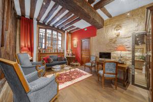 a living room with a couch and chairs at Hotel de la Bretonnerie in Paris