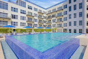 a large swimming pool in front of a building at Hh-3Bs612 - Amazing Beach Condo Oceanfront In Aruba! in Oranjestad