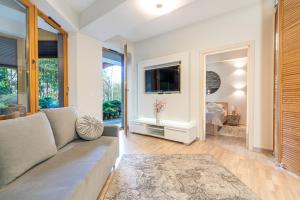 a living room with a couch and a large window at Aqua Park Residence VIPAPARTAMENTY in Zakopane +71 photos