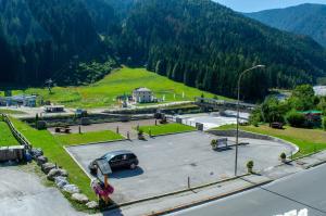 a parking lot with a car parked in a park at Hotel Serena - Tre Cime Views in Auronzo di Cadore