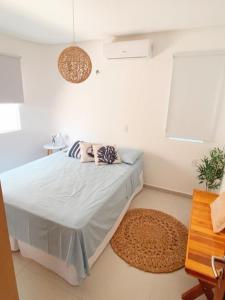 a bedroom with a bed with two pillows on it at Condomínio Vila do Mar - Apartamento 3 quartos in Luis Correia +13 photos