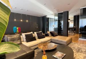 a living room with a couch and a table at Langhe Panorama in Alba +22 photos