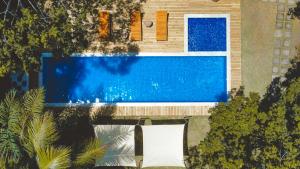 an overhead view of a swimming pool in front of a house at Villa Cacau - Floresta in Trancoso