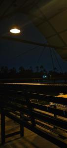 a light on top of a bench at night at Flumen Resort in Ernakulam