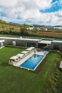 an overhead view of a swimming pool with umbrellas at Lusitano Garden Villas in Ponta Delgada