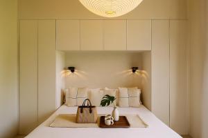 a bedroom with a bed with white walls at The Boulevard by Aspasios in Barcelona