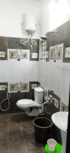a bathroom with a toilet and a sink at Ruby bungalow in Ooty