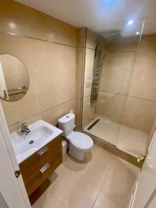 a bathroom with a toilet and a sink and a shower at Townhouse in Manilva in Manilva