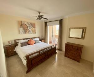 a bedroom with a bed and a ceiling fan at Townhouse in Manilva in Manilva