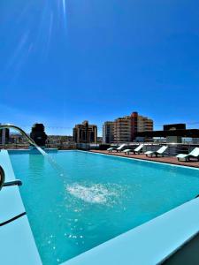 a swimming pool on top of a building at Central Suites Hotel in Villa Carlos Paz