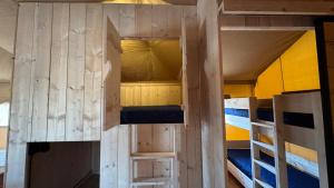 a small room with two bunk beds in it at Safari Lodge B in Petten