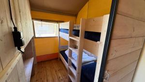 a small room with two bunk beds in it at Safari Lodge B in Petten +10 photos